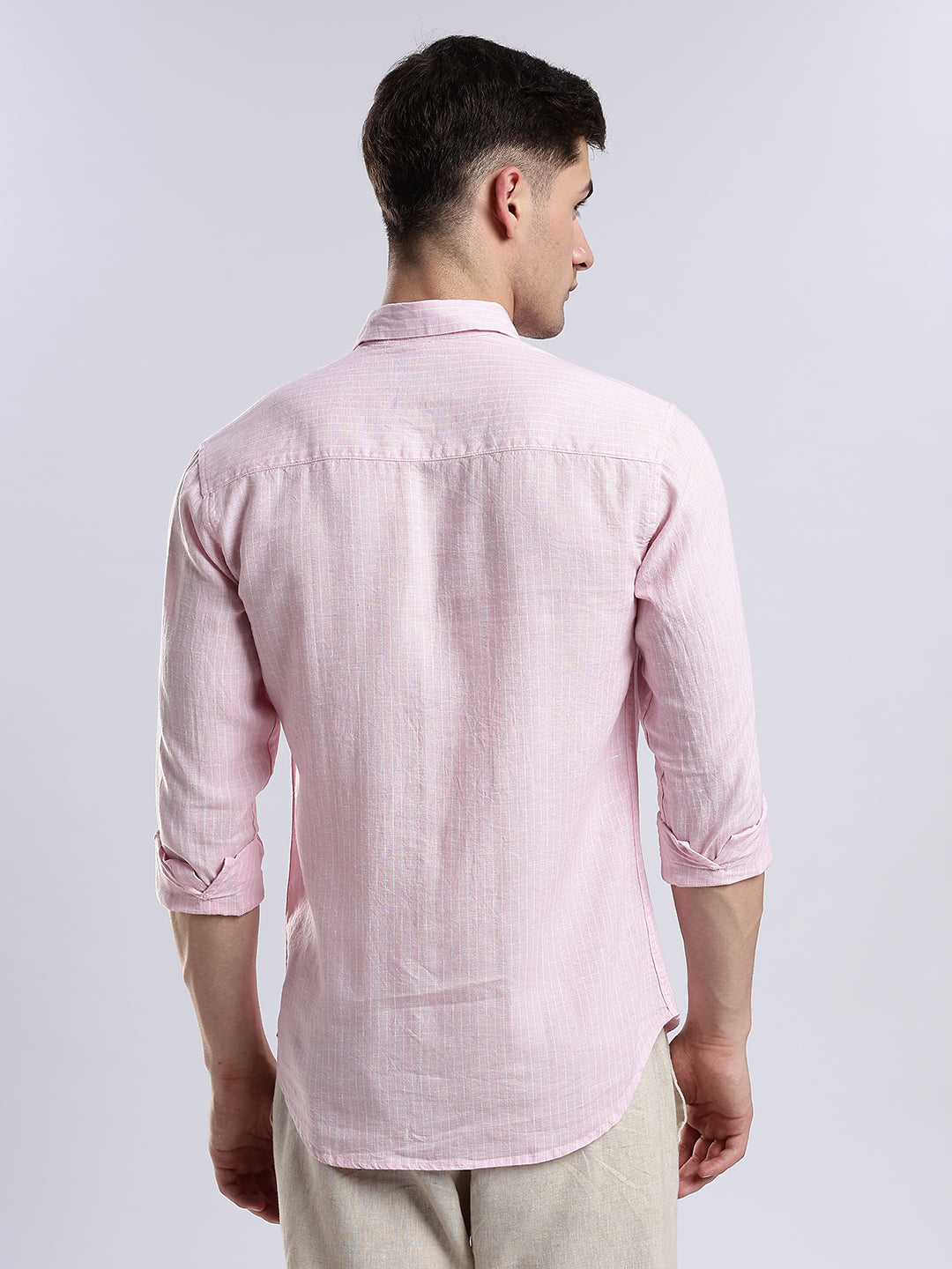 Close-up of a minimalist pink button-down shirt in high-quality breathable fabric.