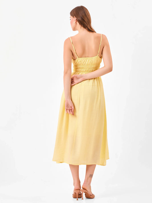 Female model wearing a yellow midi dress from Stylera, showcasing backside