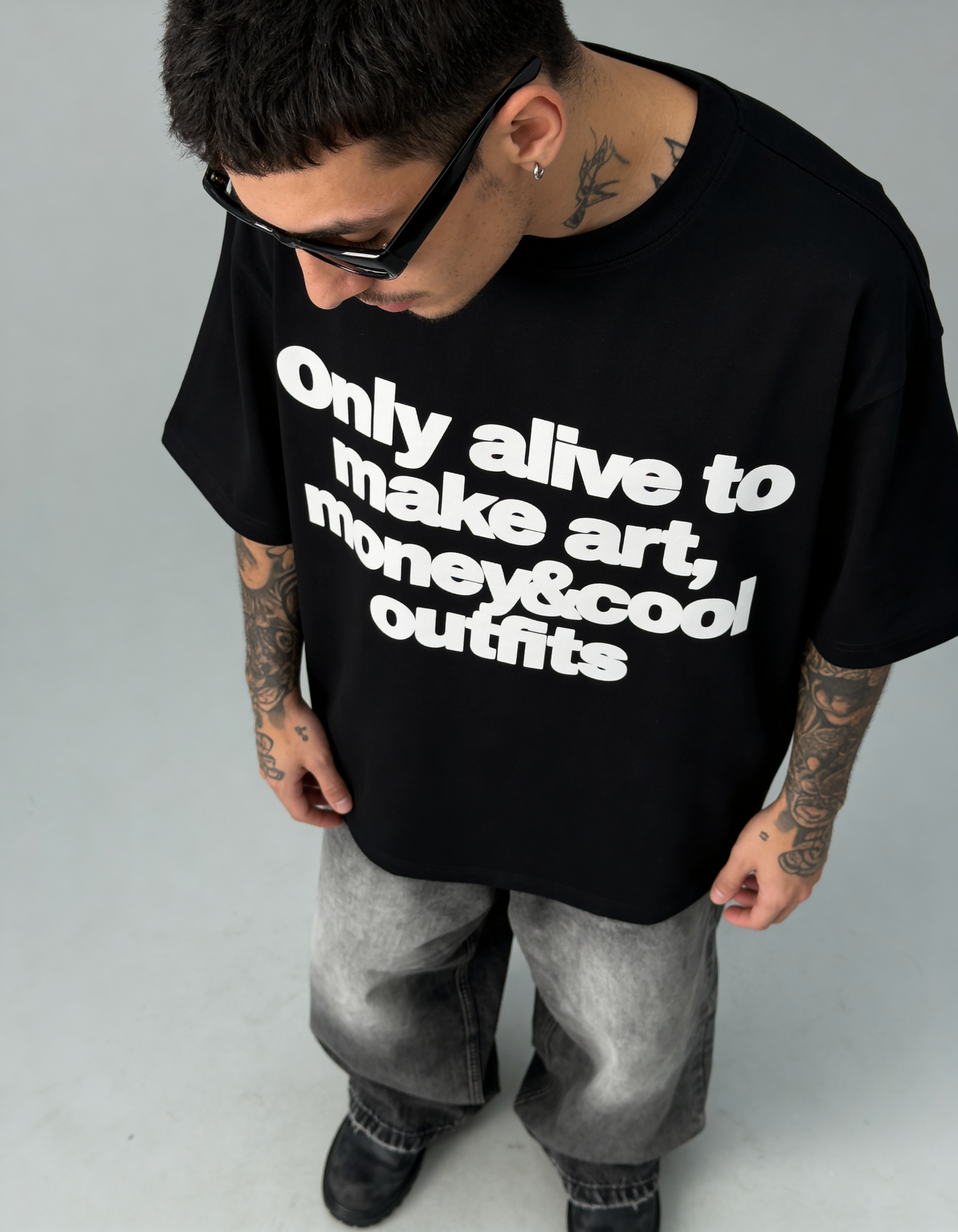 Person wearing a black t-shirt with white text on a gray background