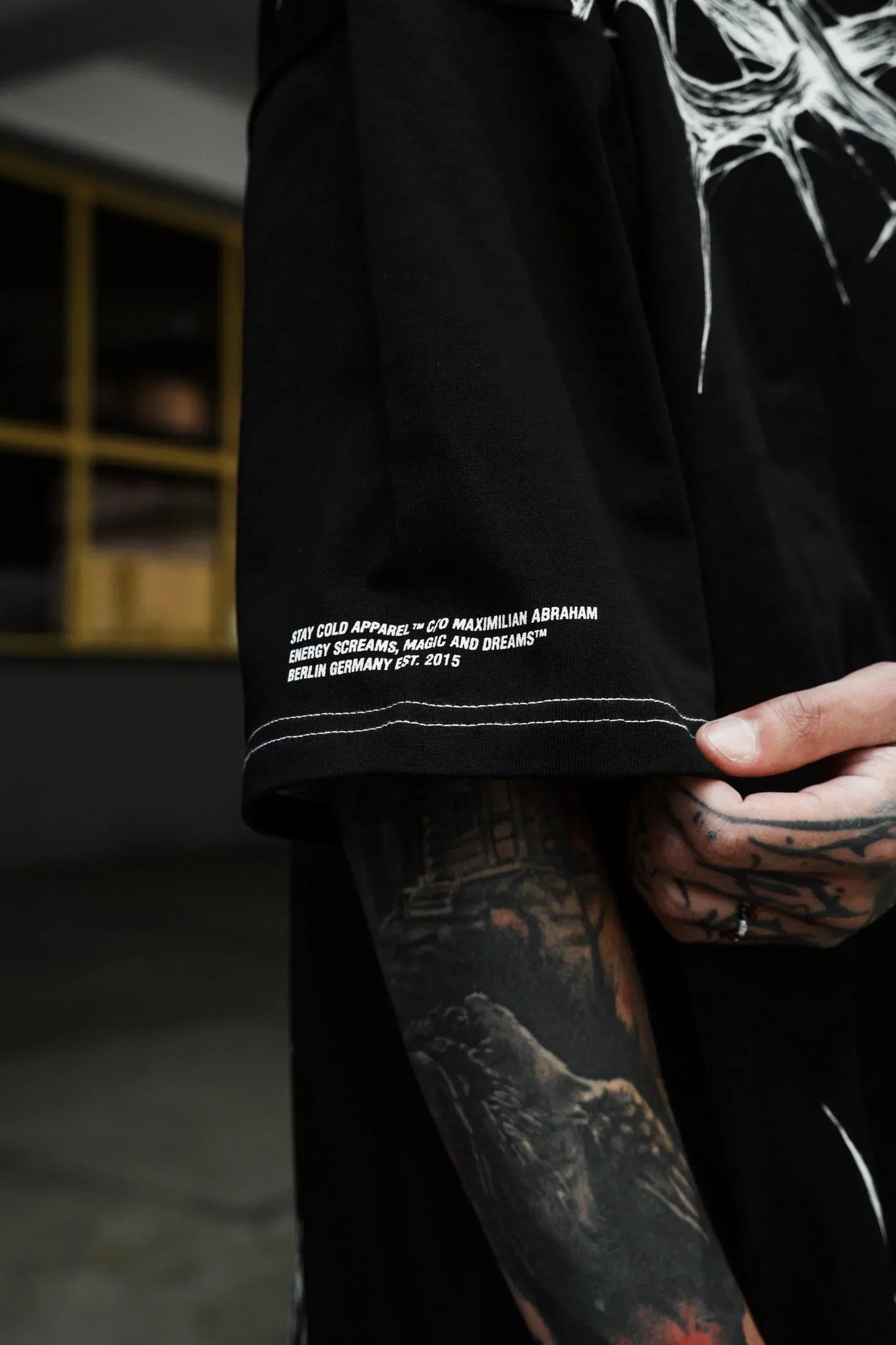Back view showing the relaxed, edgy streetwear tshirt silhouette crafted in 240 GSM black cotton