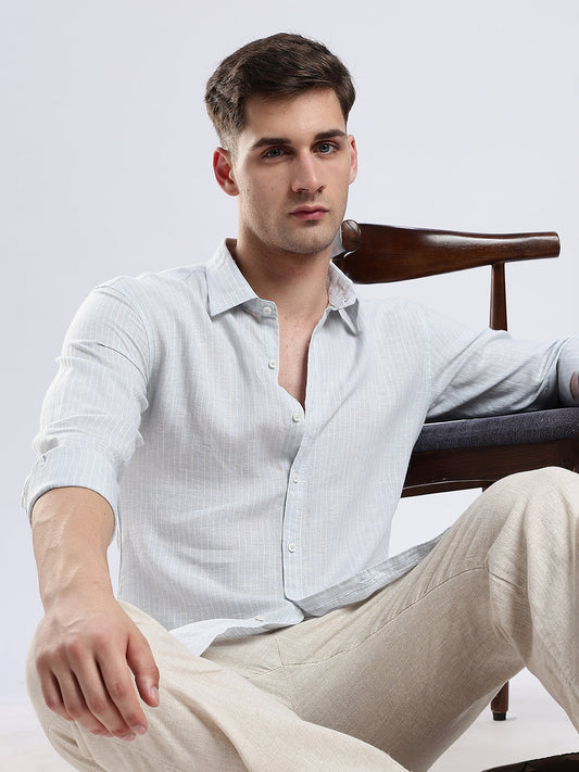 Detail shot of a structured spread collar on a pale blue textured button-down shirt.