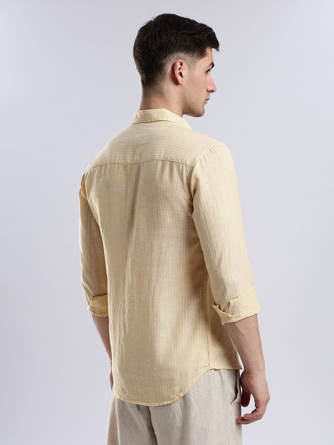 Minimalist pale yellow linen-blend button-up shirt for men, perfect for smart-casual spring layering.