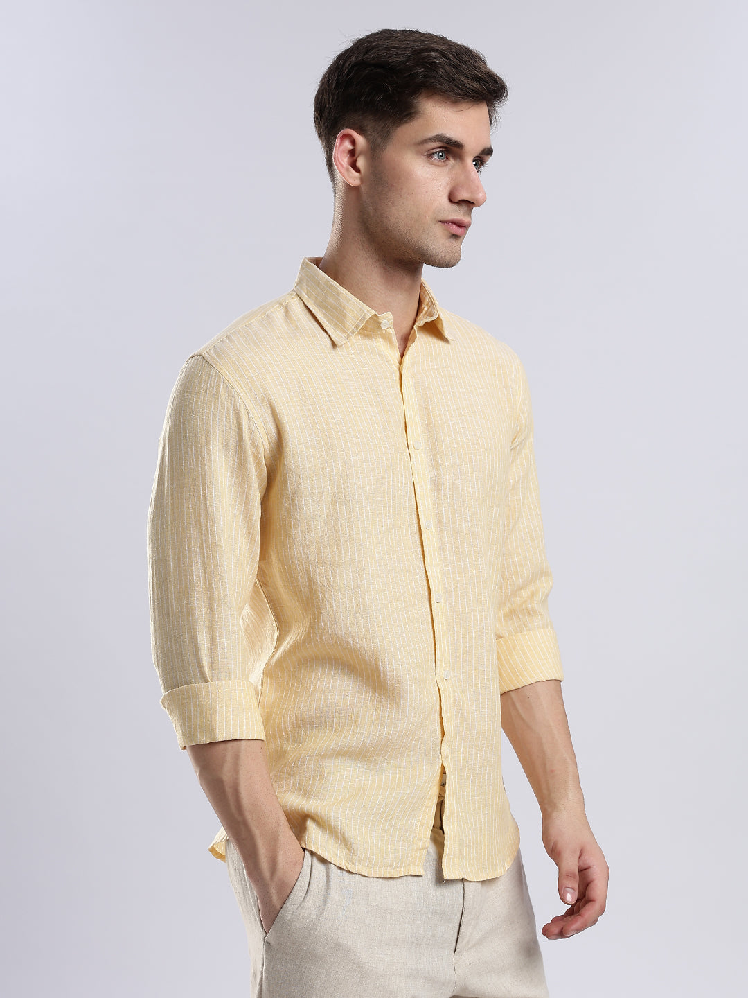 Men's casual yellow linen shirt styled with rolled sleeves for a relaxed summer or vacation look.