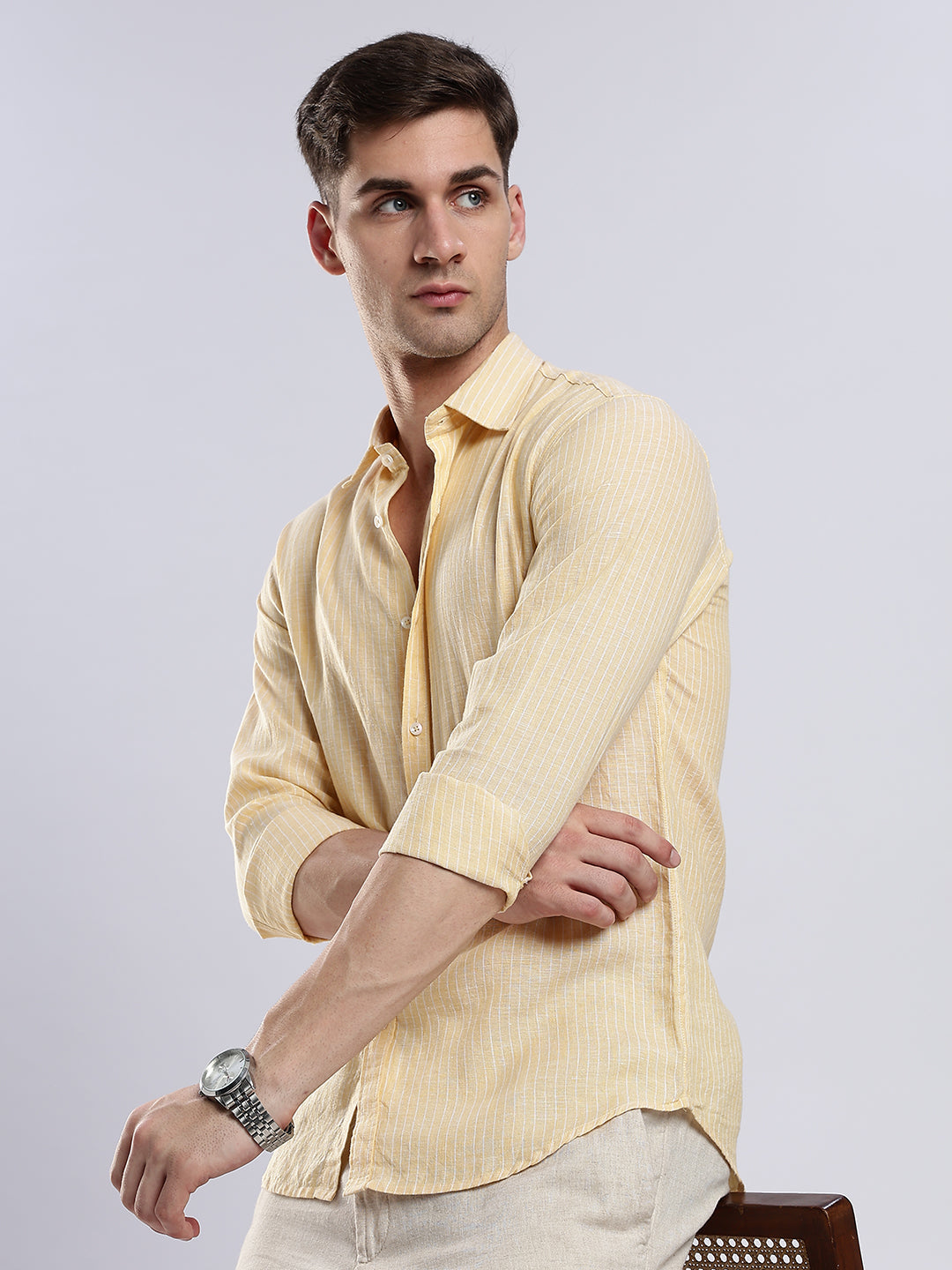 Stylera men’s pale yellow linen-blend shirt in a slim fit paired with off-white trousers.
