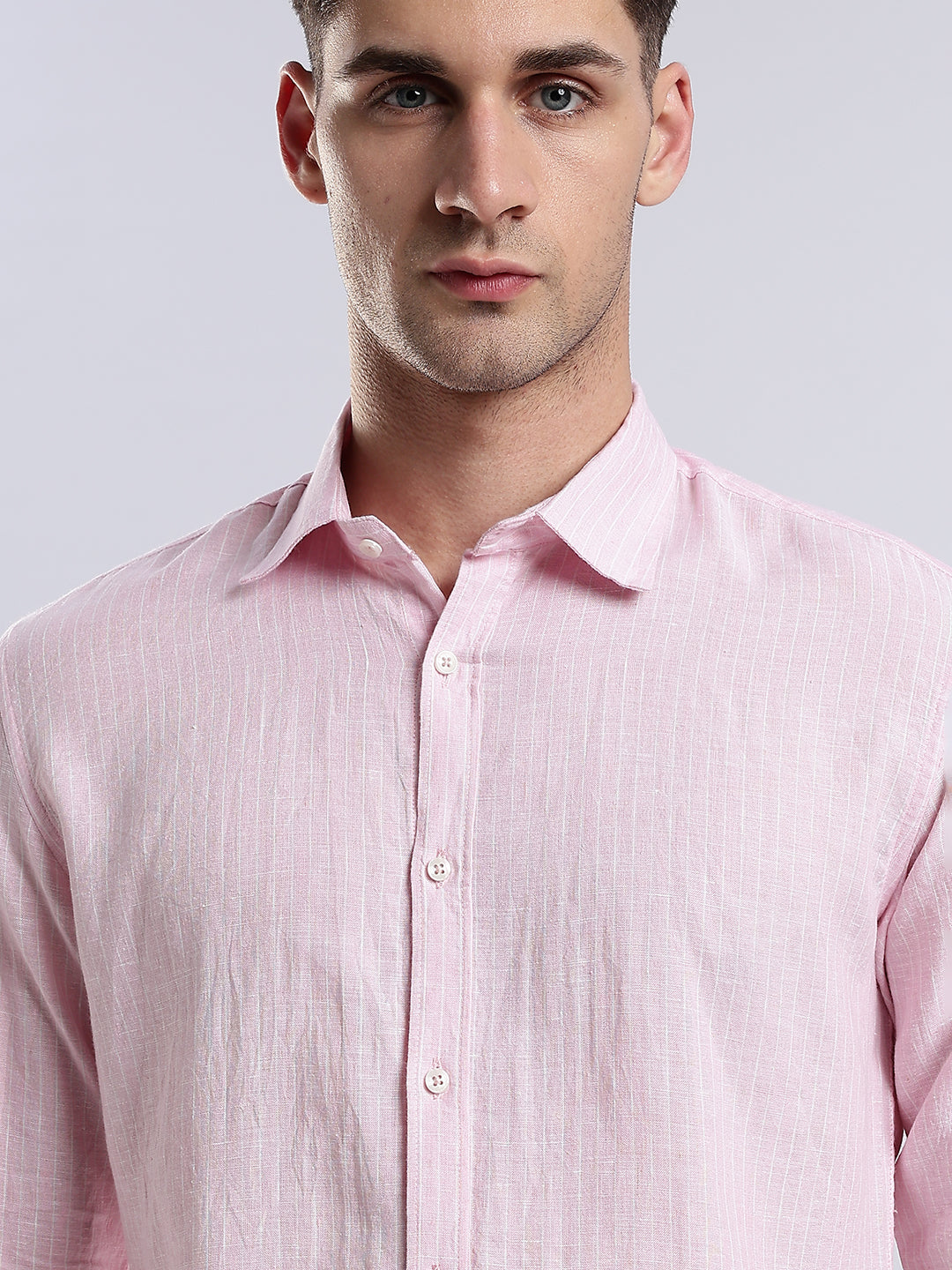 Rear view of a slim-fit pink linen shirt for men showing clean seams and a tailored hem.