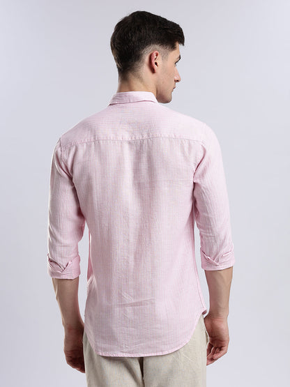 Close-up of a minimalist pink button-down shirt in high-quality breathable fabric.