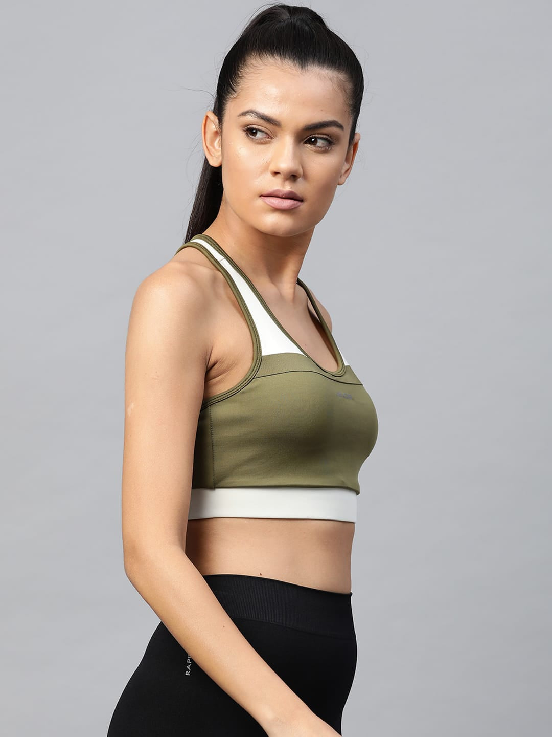 Alcis olive green full coverage padded workout bra for women with breathable knitted fabric for fitness activities.
