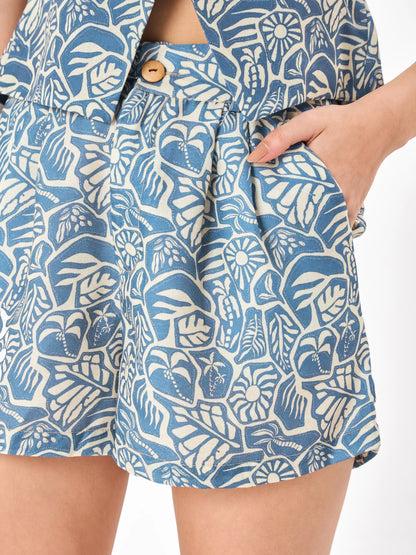 Female model wearing a blue patterned co-ord set includes crop top & button closure shorts from Stylera