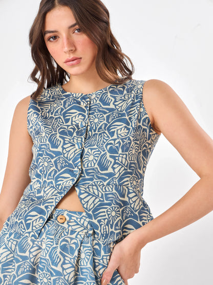Female model wearing a blue patterned co-ord set includes button down crop top & shorts from Stylera