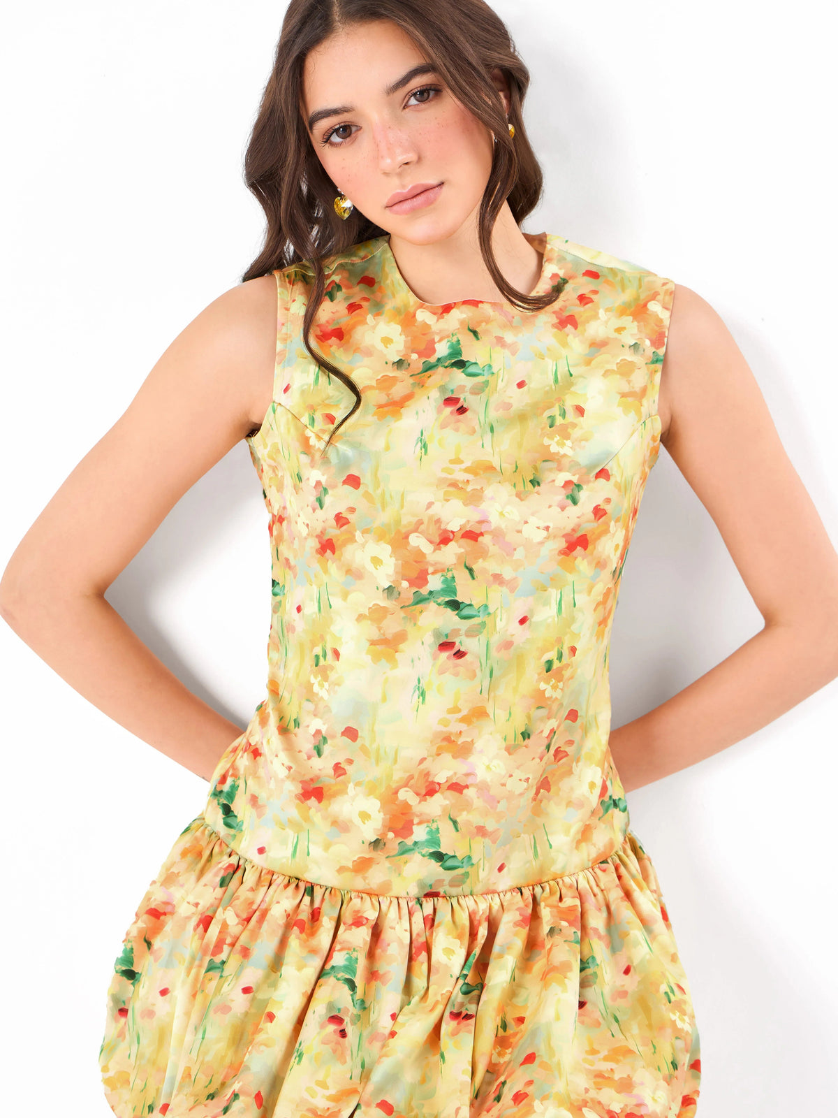 Female model wearing a round neck floral yellow dress from Stylera