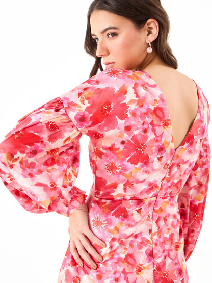 Female model wearing a Vneck on back pink floral mini dress from Stylera