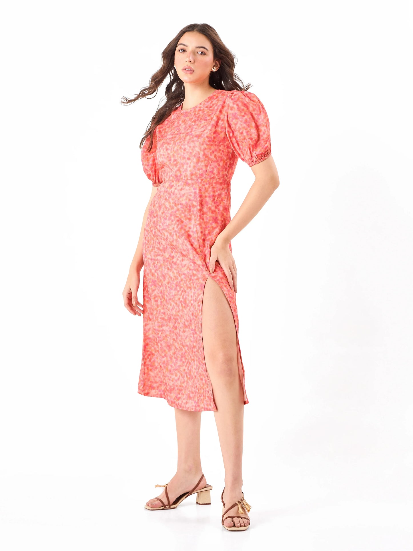 Female model wearing a split cut coral pink floral dress from Stylera
