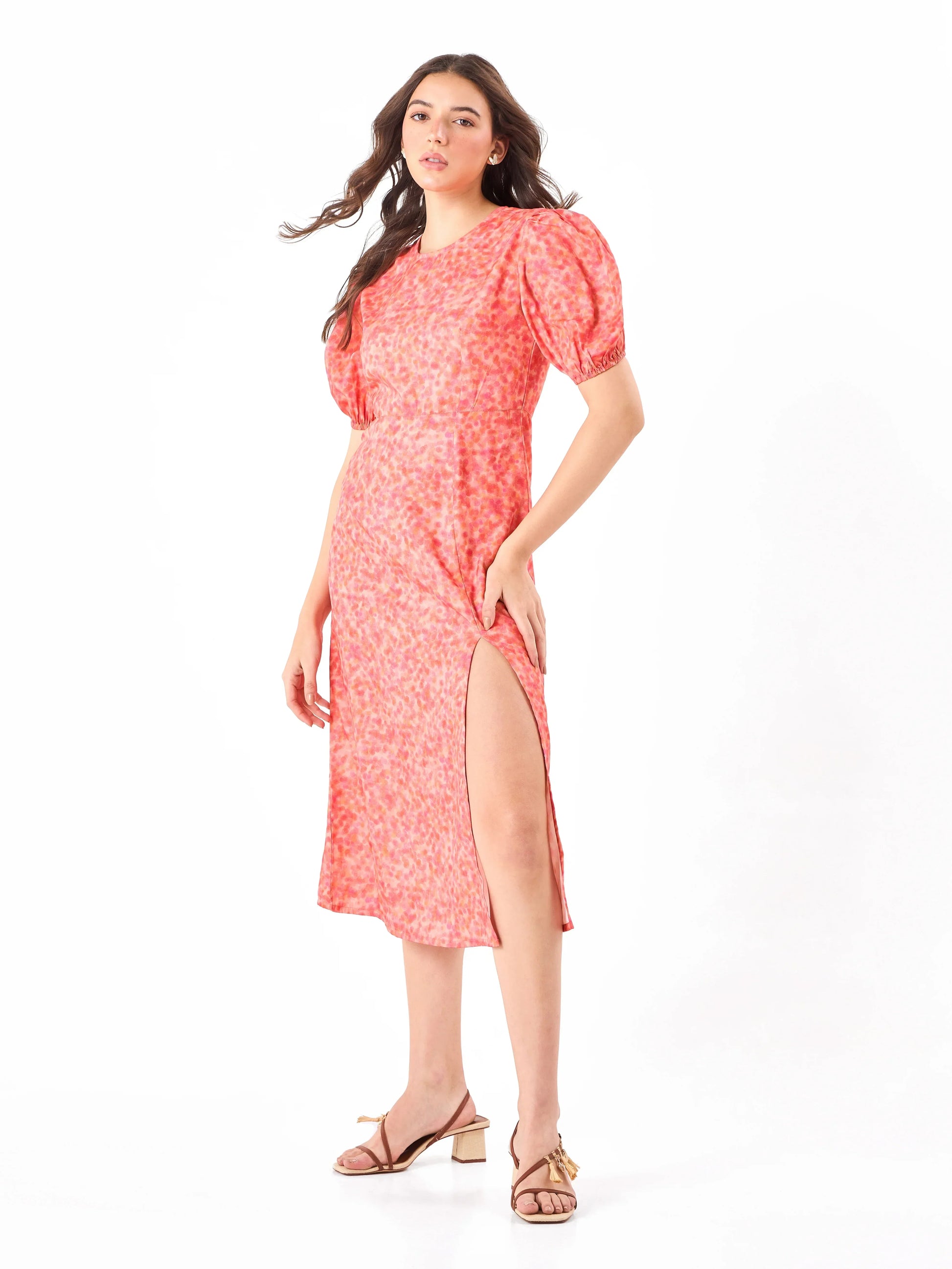 Female model wearing a split cut coral pink floral dress from Stylera