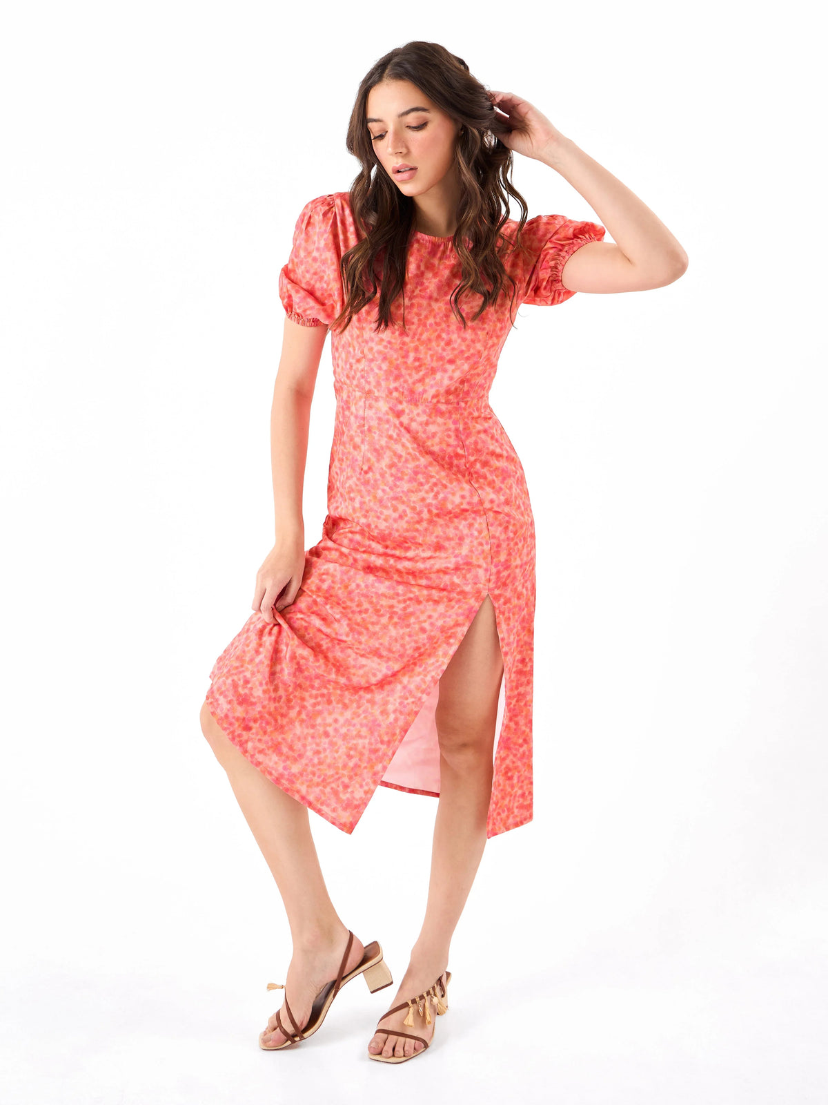 Female model wearing a coral pink floral dress from Stylera