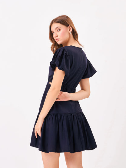Female model wearing a navy blue dress from Stylera, showcasing backside