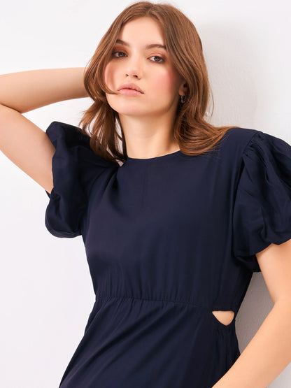 Female model wearing a navy blue puff sleeve dress from Stylera