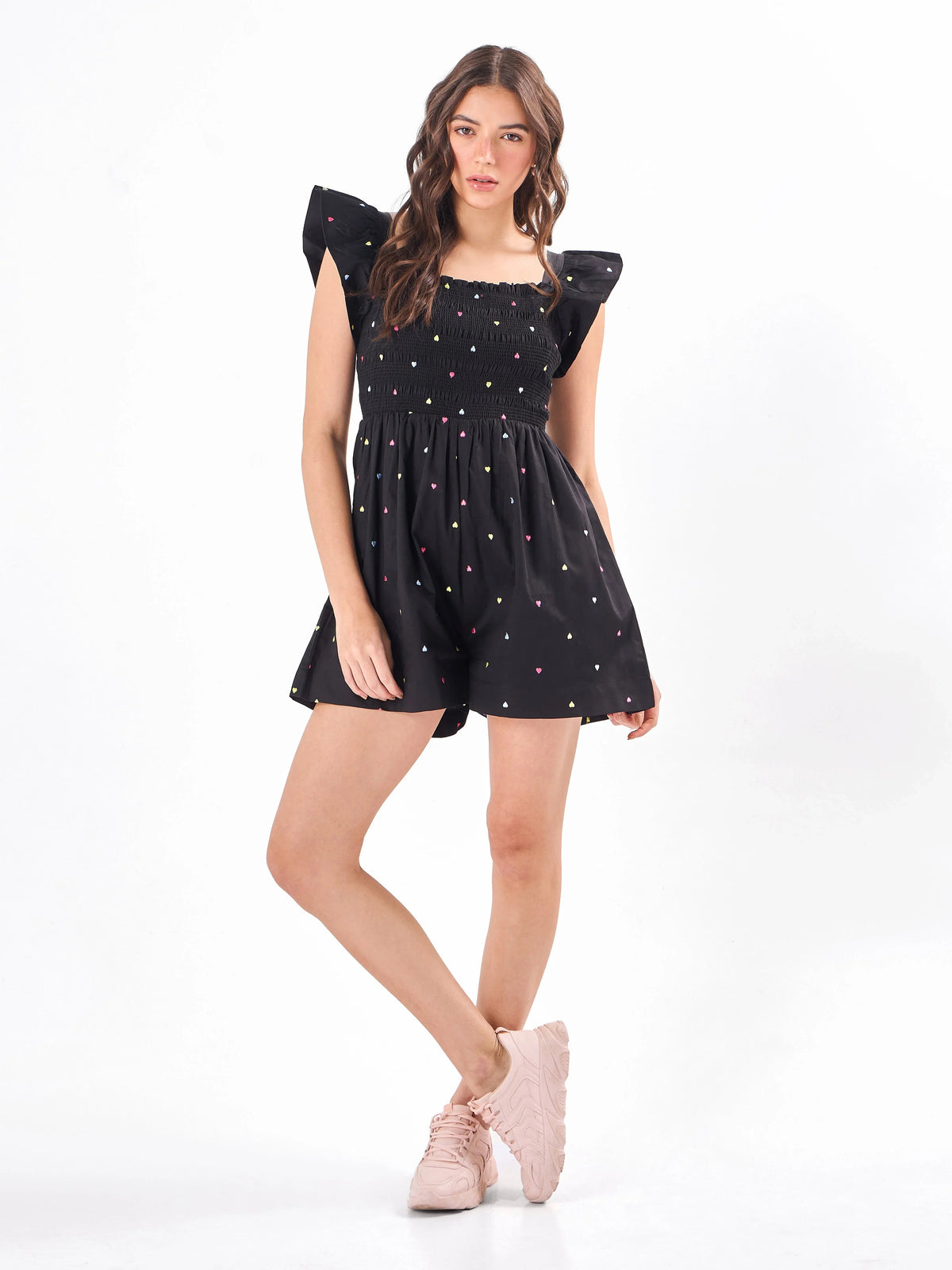 Female model wearing a embroidered black romper from Stylera