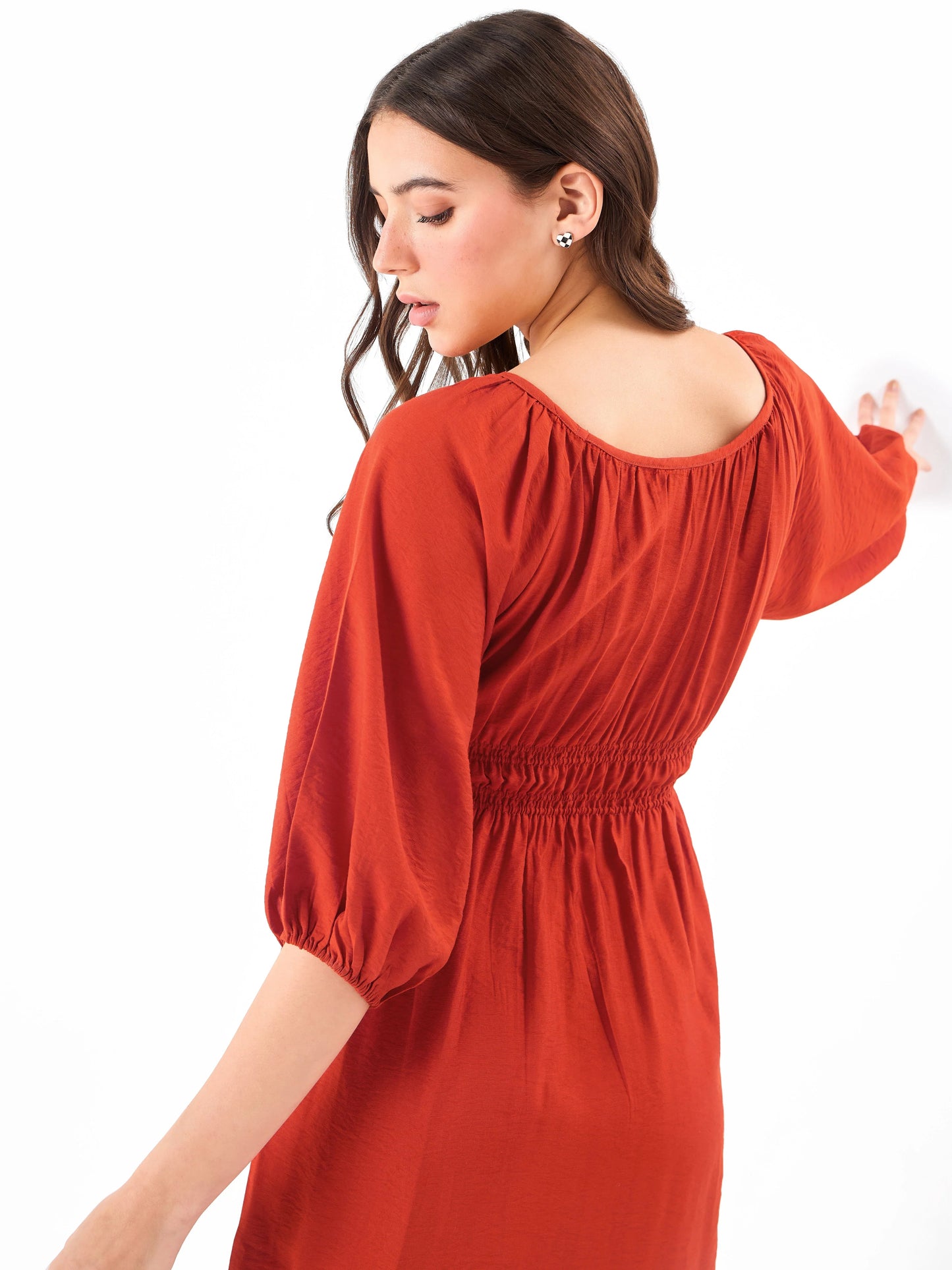 Female model wearing a red shirring dress from Stylera