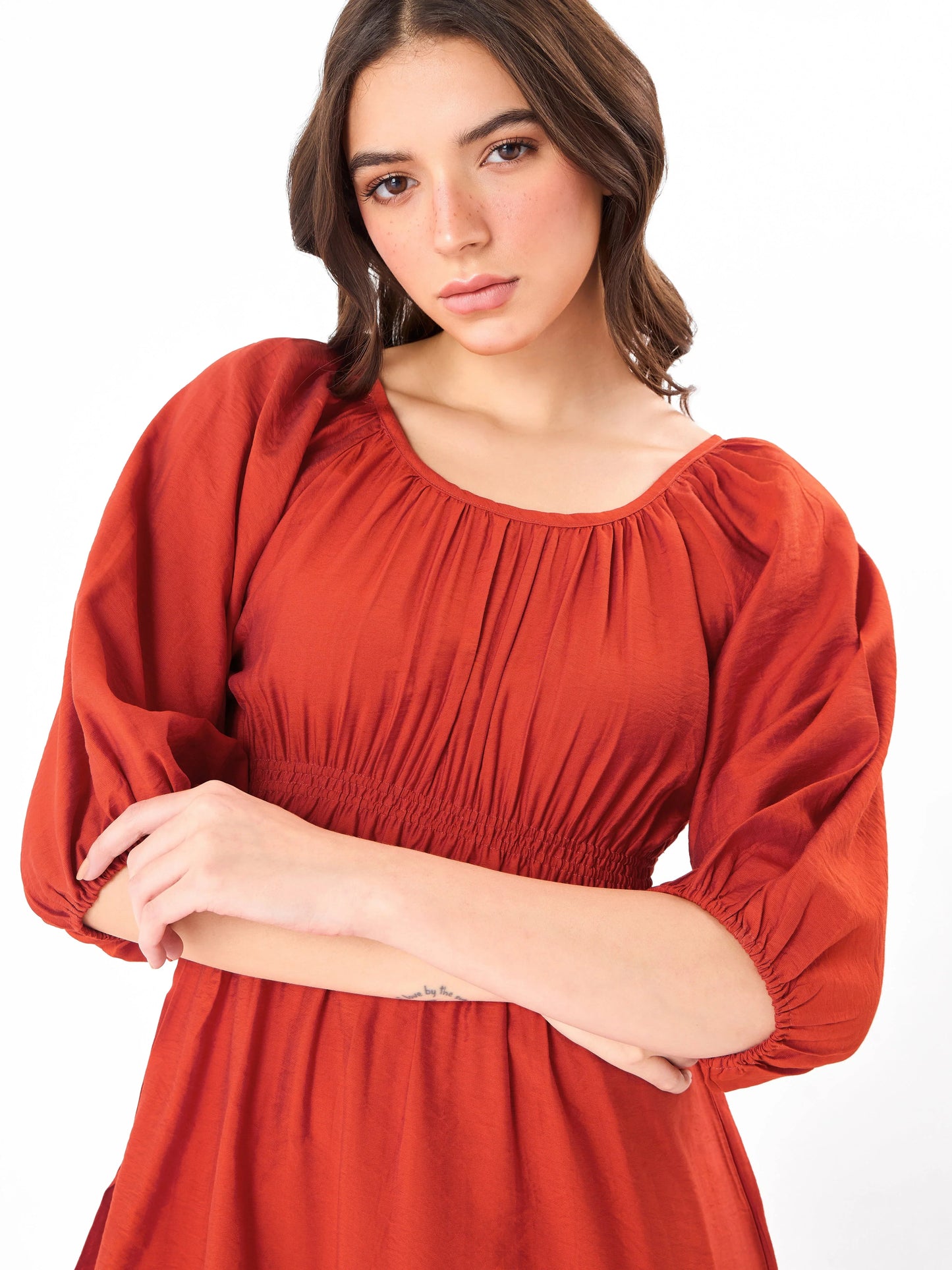 Female model wearing a red round neck shirring dress from Stylera