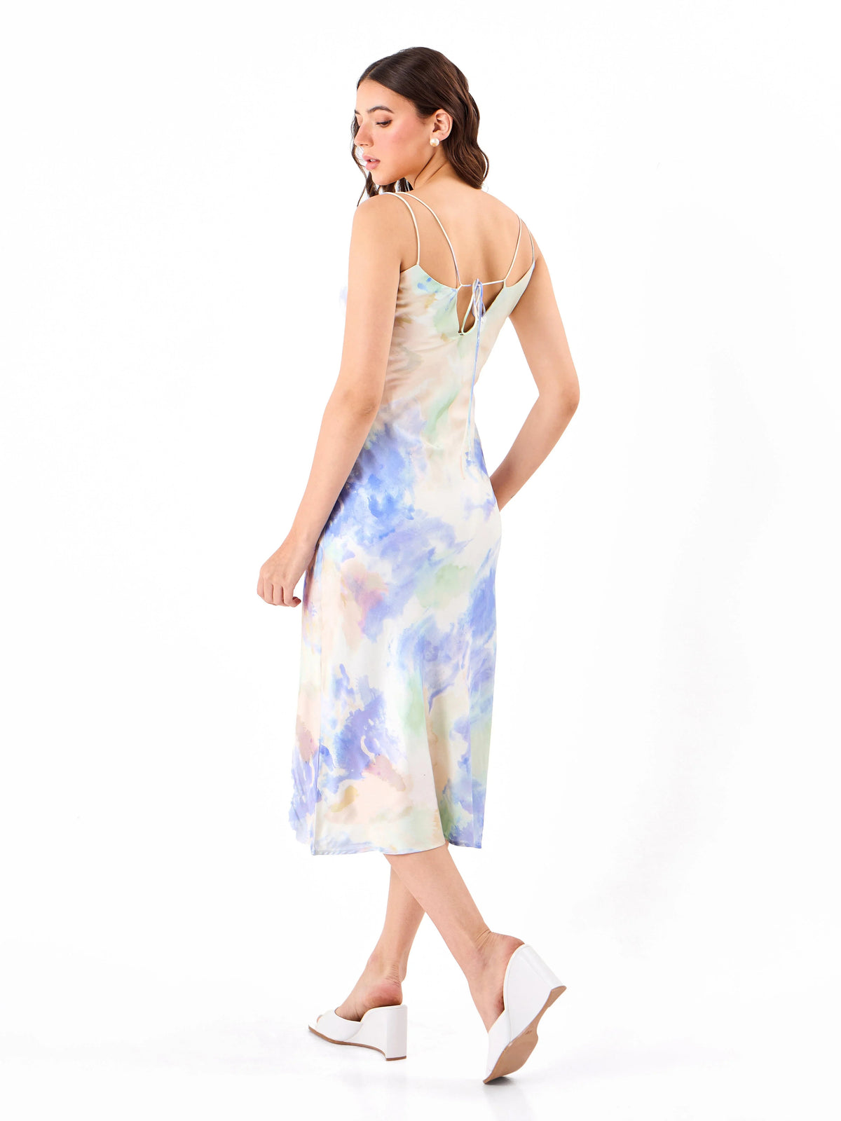 Female model wearing a multicoloured slip dress from Stylera,  showcasing backside
