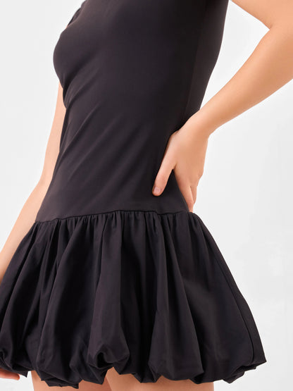 Female model wearing a black sleeveless cotton dress with a flared skirt from Stylera