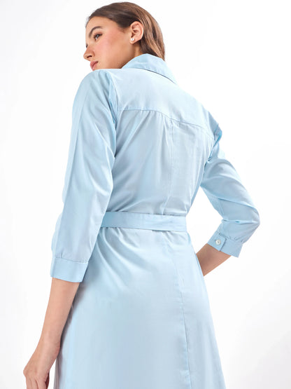 Female model wearing a light blue and orange dress with a belt from Stylera