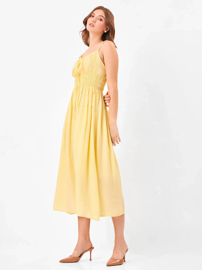 Female model wearing a spaghetti strap yellow midi dress from Stylera