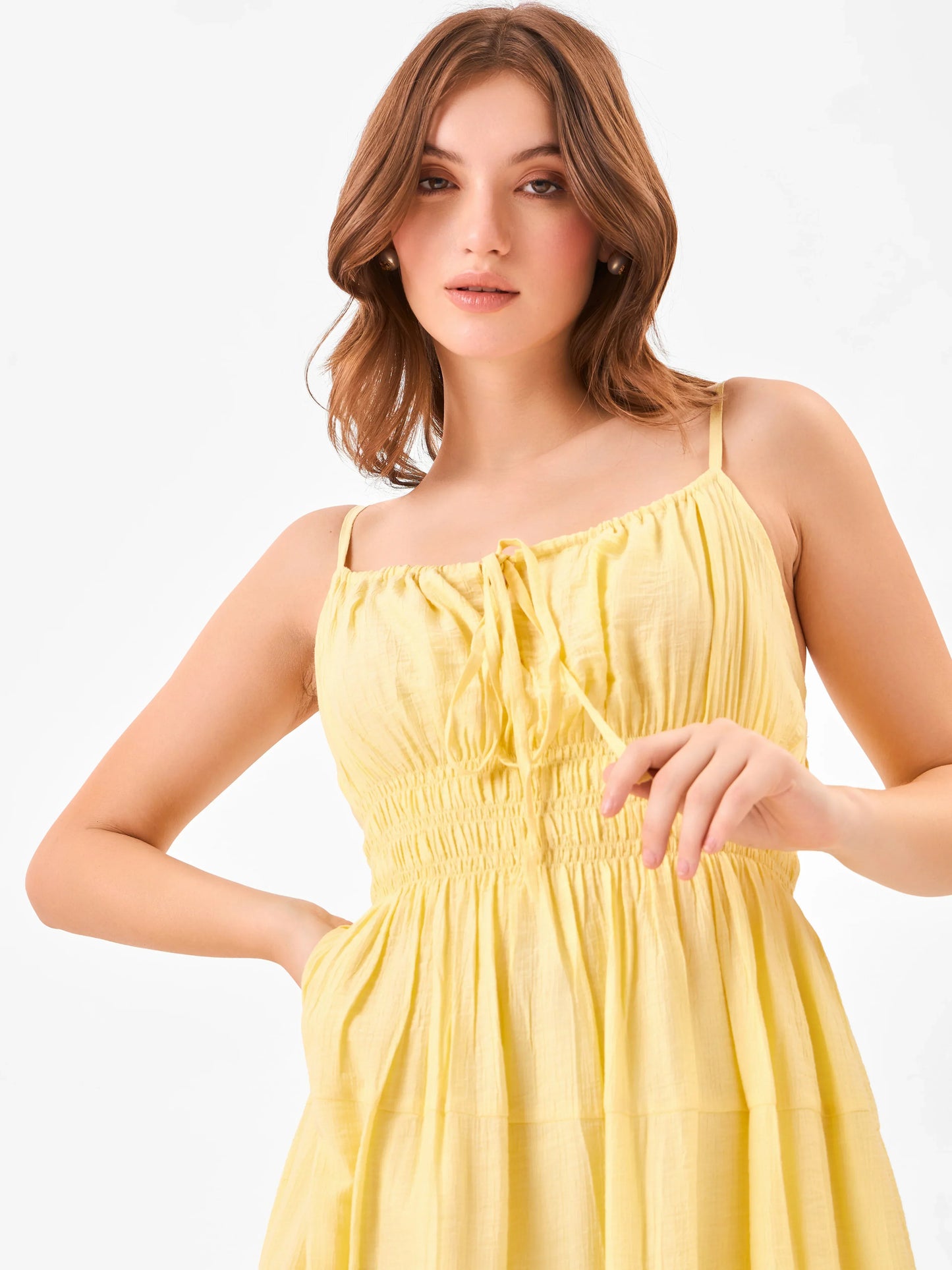 Female model wearing a yellow midi dress with elastic waist detail from Stylera