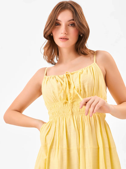 Female model wearing a yellow midi dress with elastic waist detail from Stylera