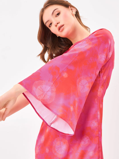 Female model wearing a pink tie-dye dress with flared sleeve from Stylera