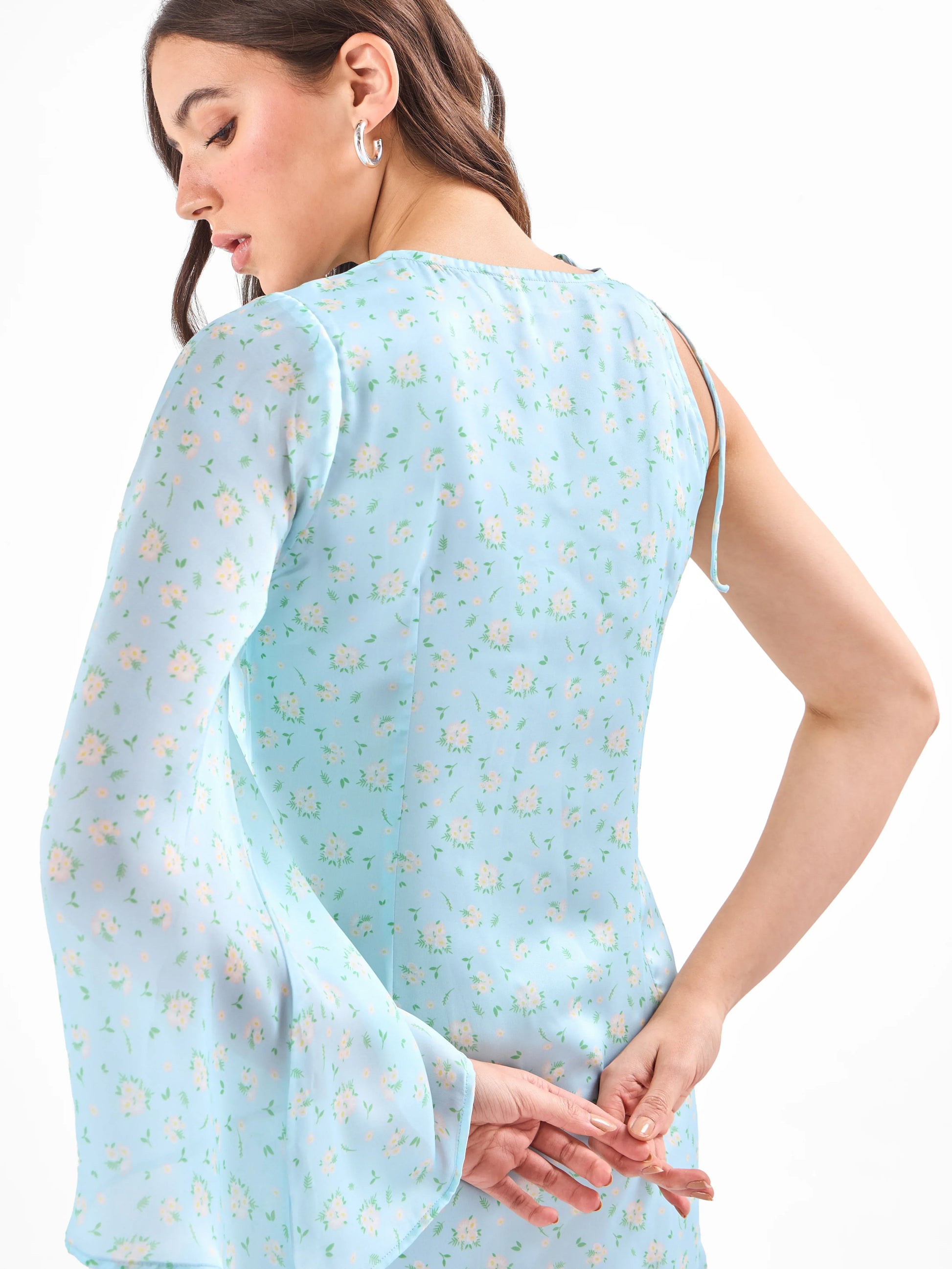 Female model wearing a floral print blue mini dress from Stylera