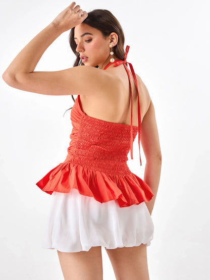 Female model wearing a orange halter top from Stylera, showcasing backside