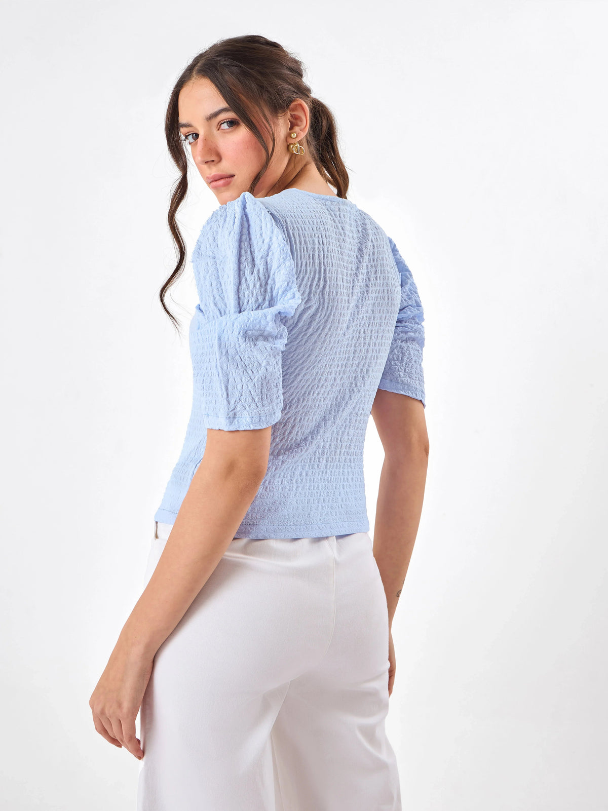 Female model wearing a light blue top medium length from Stylera