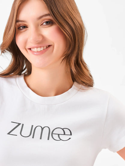 Female model wearing a round neck white t-shirt with 'Zume' logo from Stylera