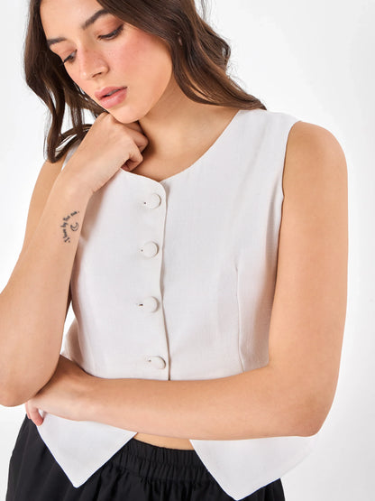 Female model wearing a crew neck white sleeveless top from Stylera