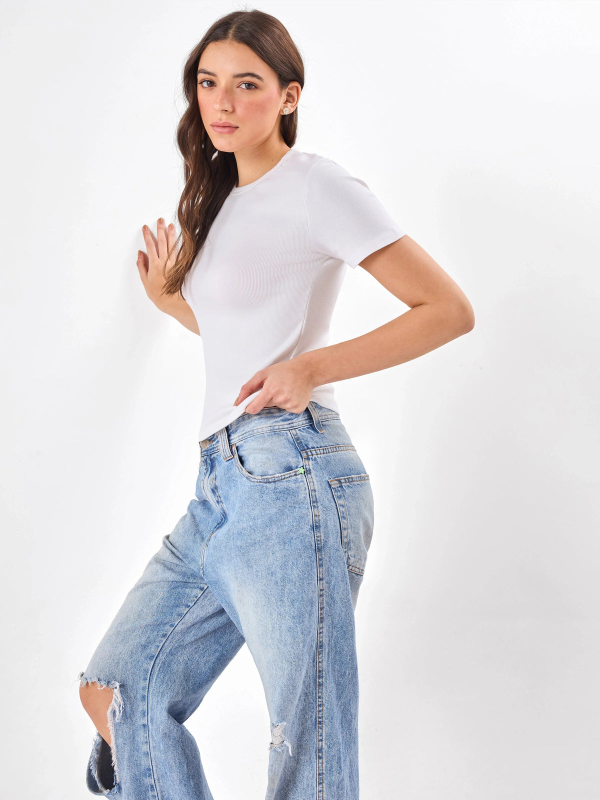 Female Model wearing white top from Stylera, showcasing side angle