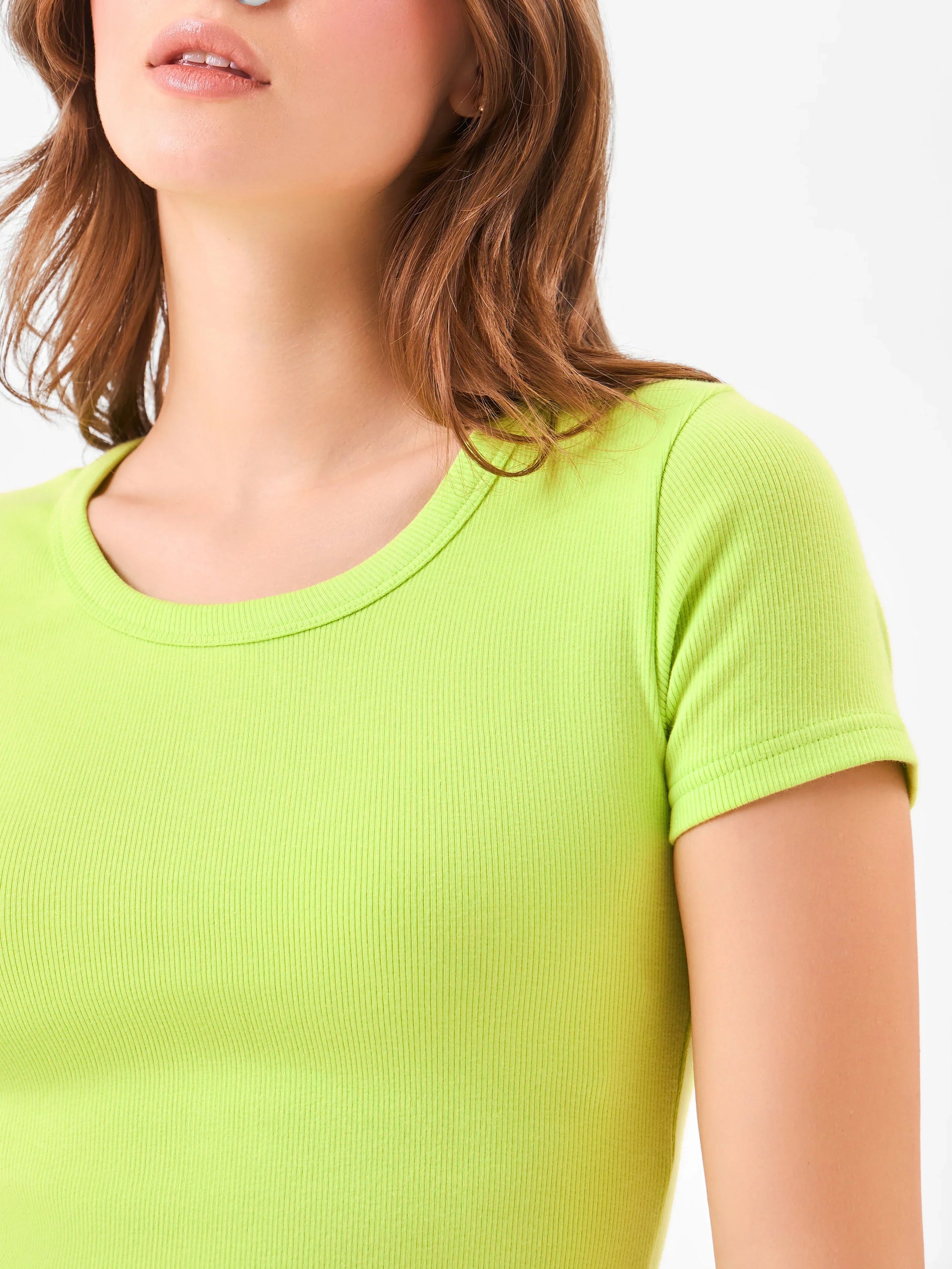 Female model wearing a cotton knitted bright green t-shirt from Stylera