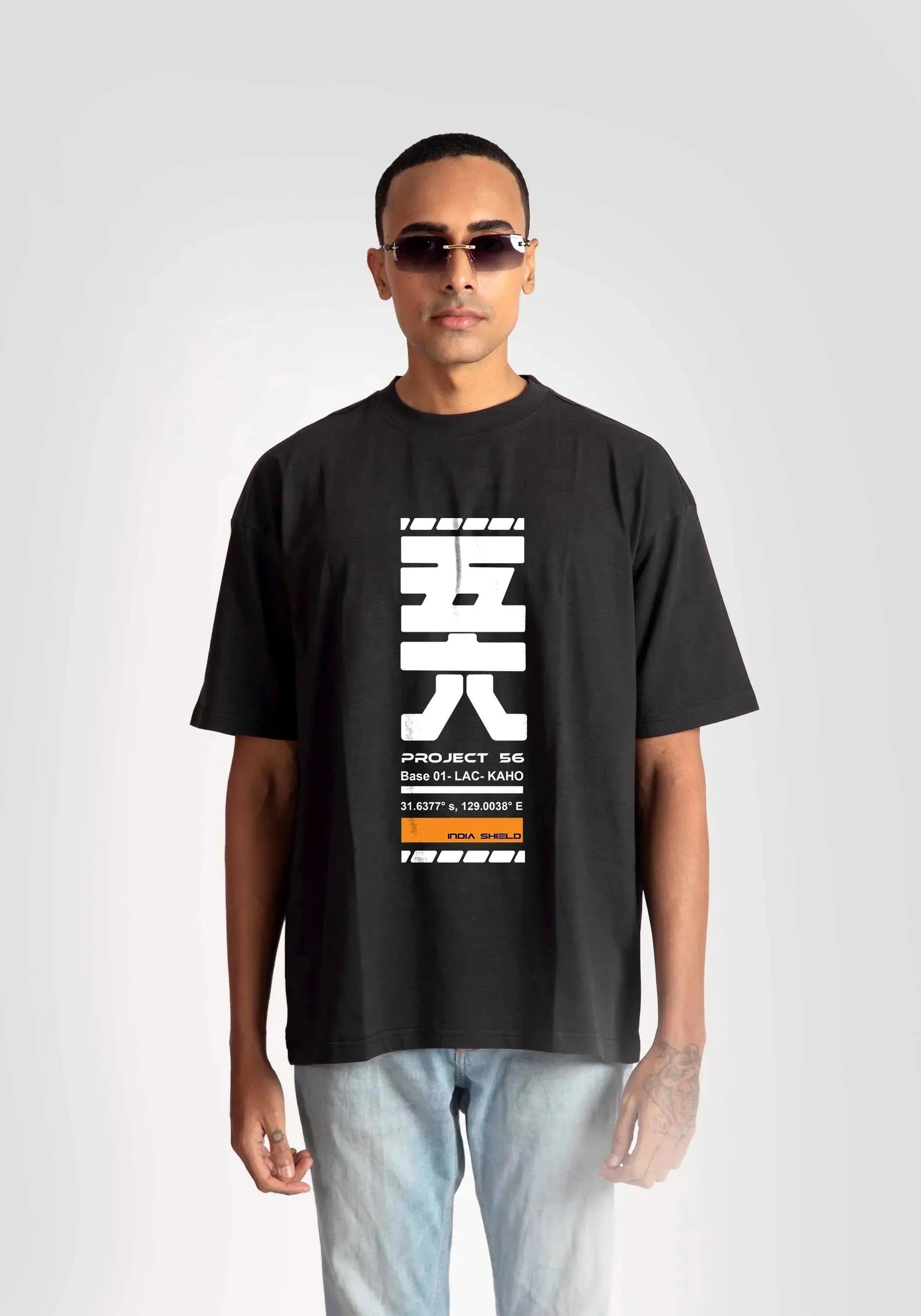 Stylera black oversized fashion t-shirt for men with white graphic print worn with light jeans