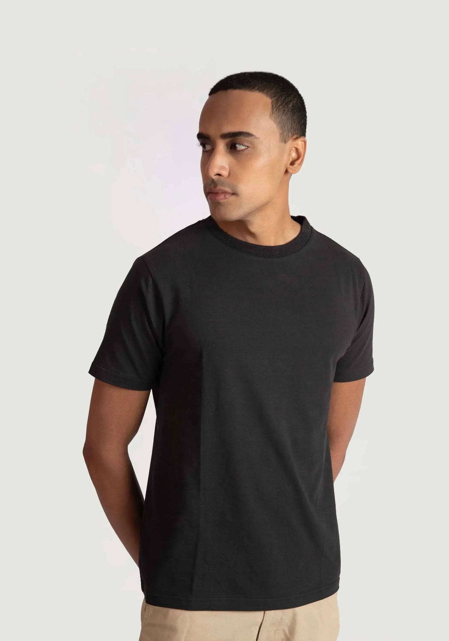 Stylera regular fit black tee for men worn by model with short sleeves and crew neck