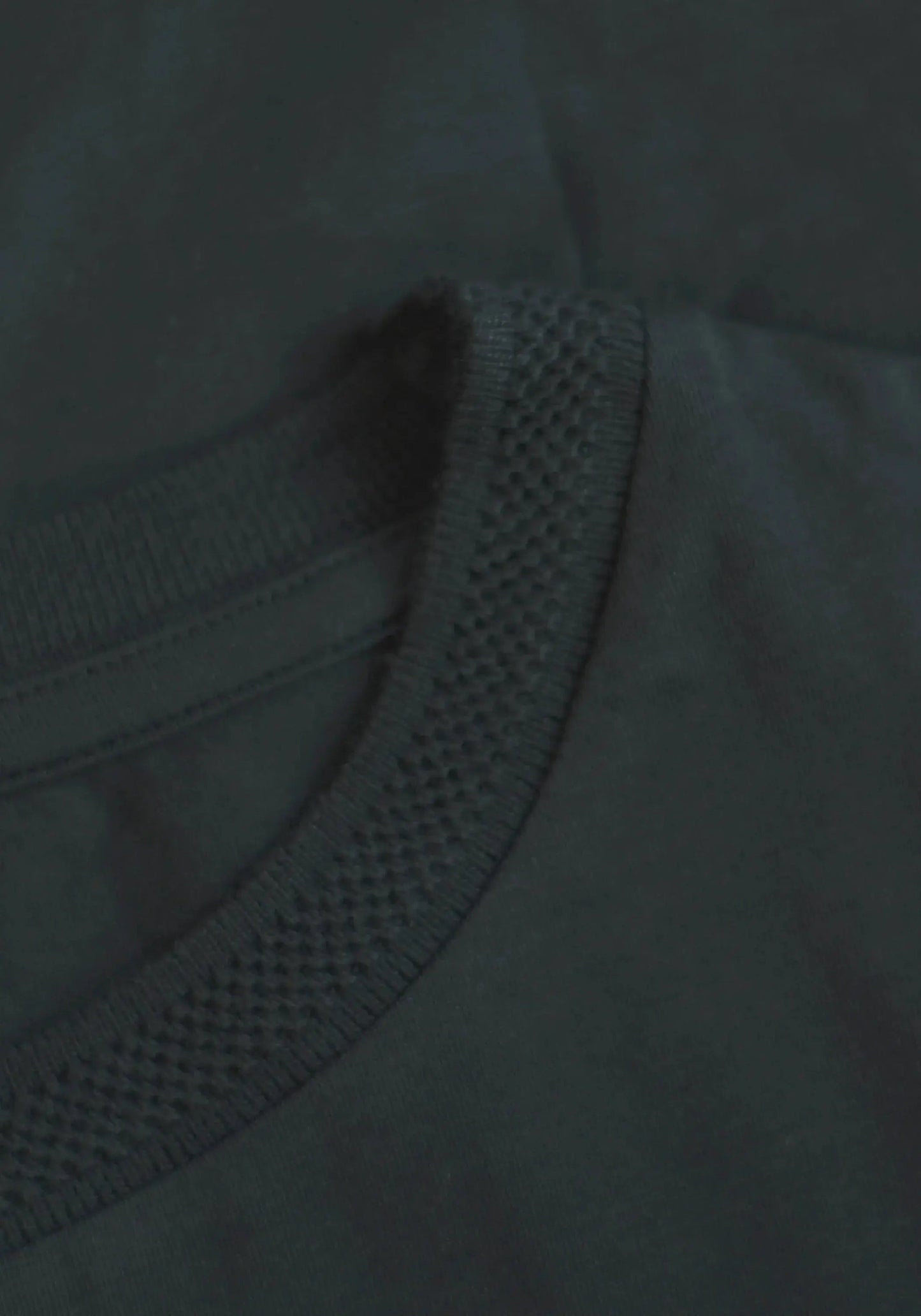 Close-up of Stylera regular fit black tee for men showing textured neckline and smooth fabric