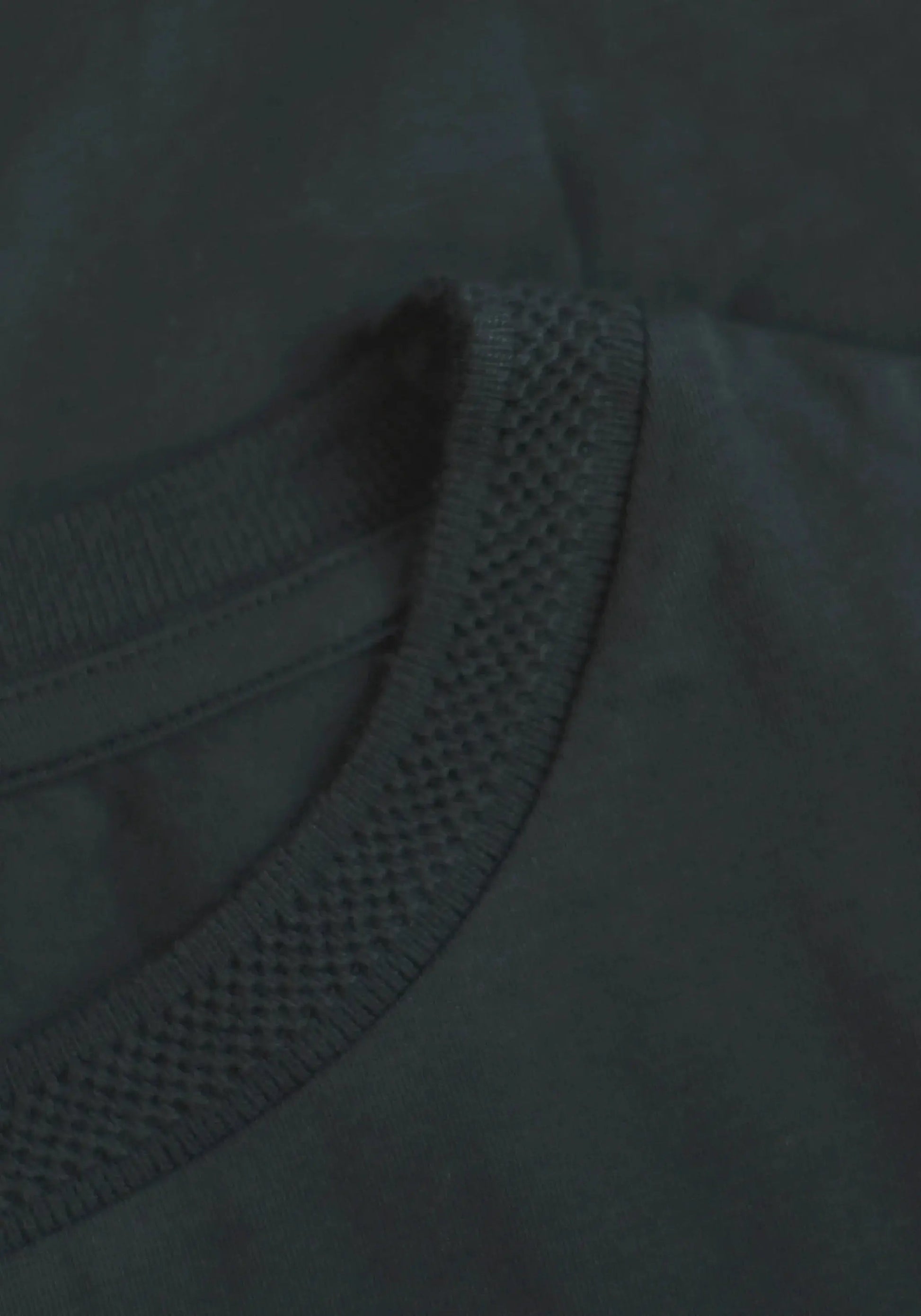 Close-up of Stylera regular fit black tee for men showing textured neckline and smooth fabric
