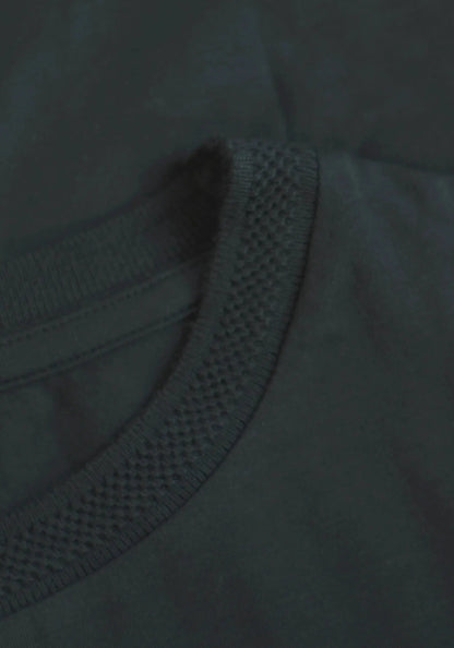 Close-up of Stylera regular fit black tee for men showing textured neckline and smooth fabric