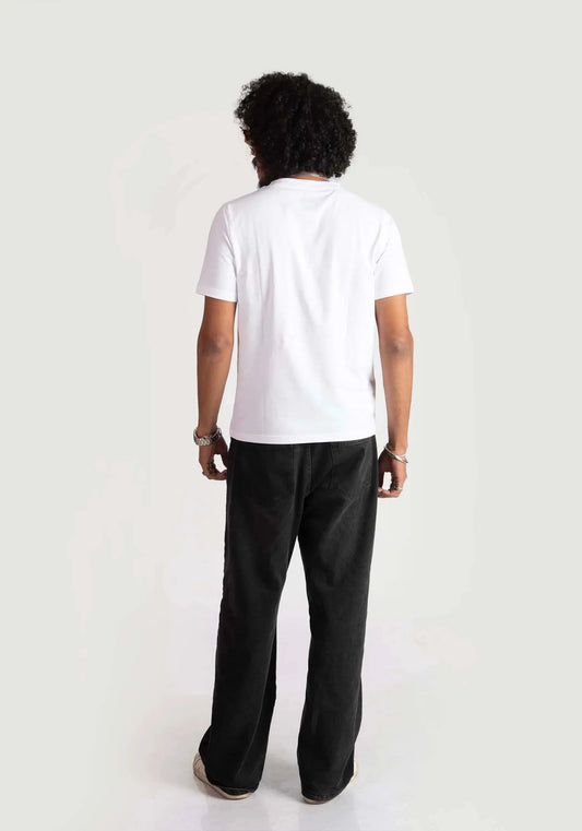 Back view of a man wearing Stylera regular fit white tee paired with black pants