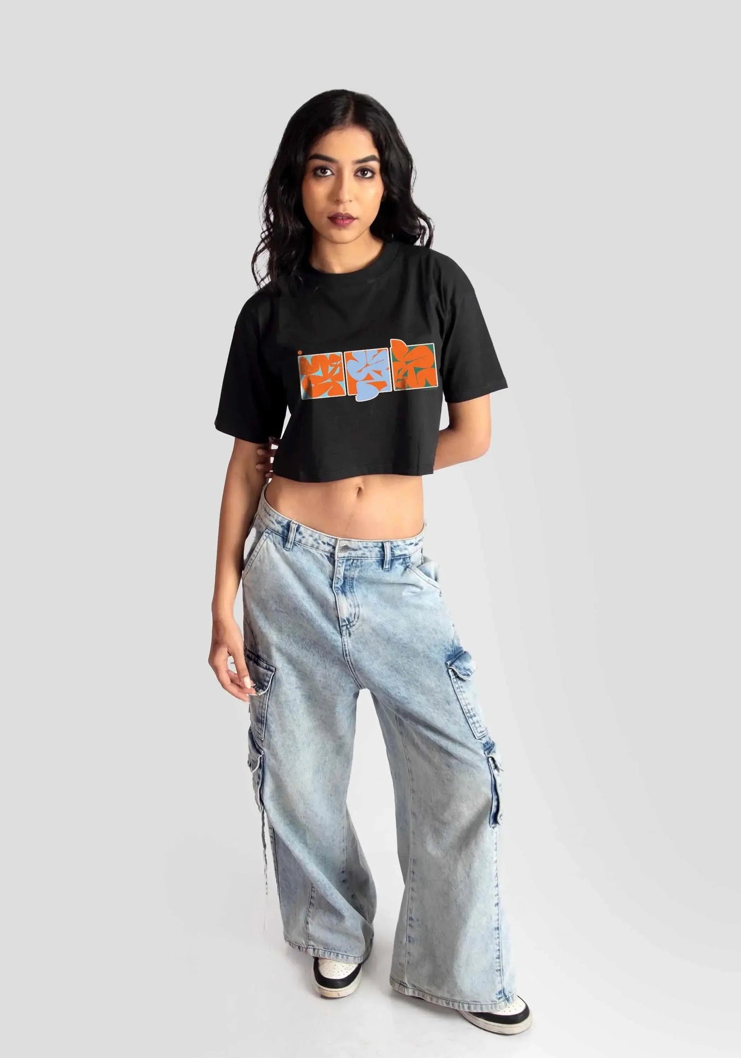 Stylera trendy black oversized crop fit t-shirt with graphic print worn with wide-leg jeans
