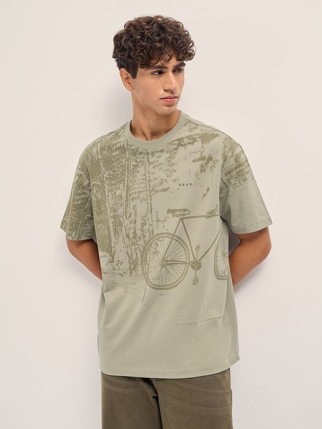 Beige Crew Neck T-Shirt with Abstract Bicycle Graphic Print