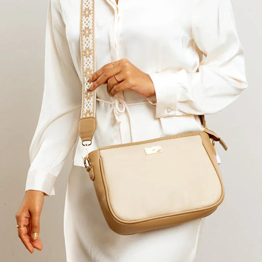 Beige crossbody purse with a stylish strap, perfect for everyday use and casual outfits