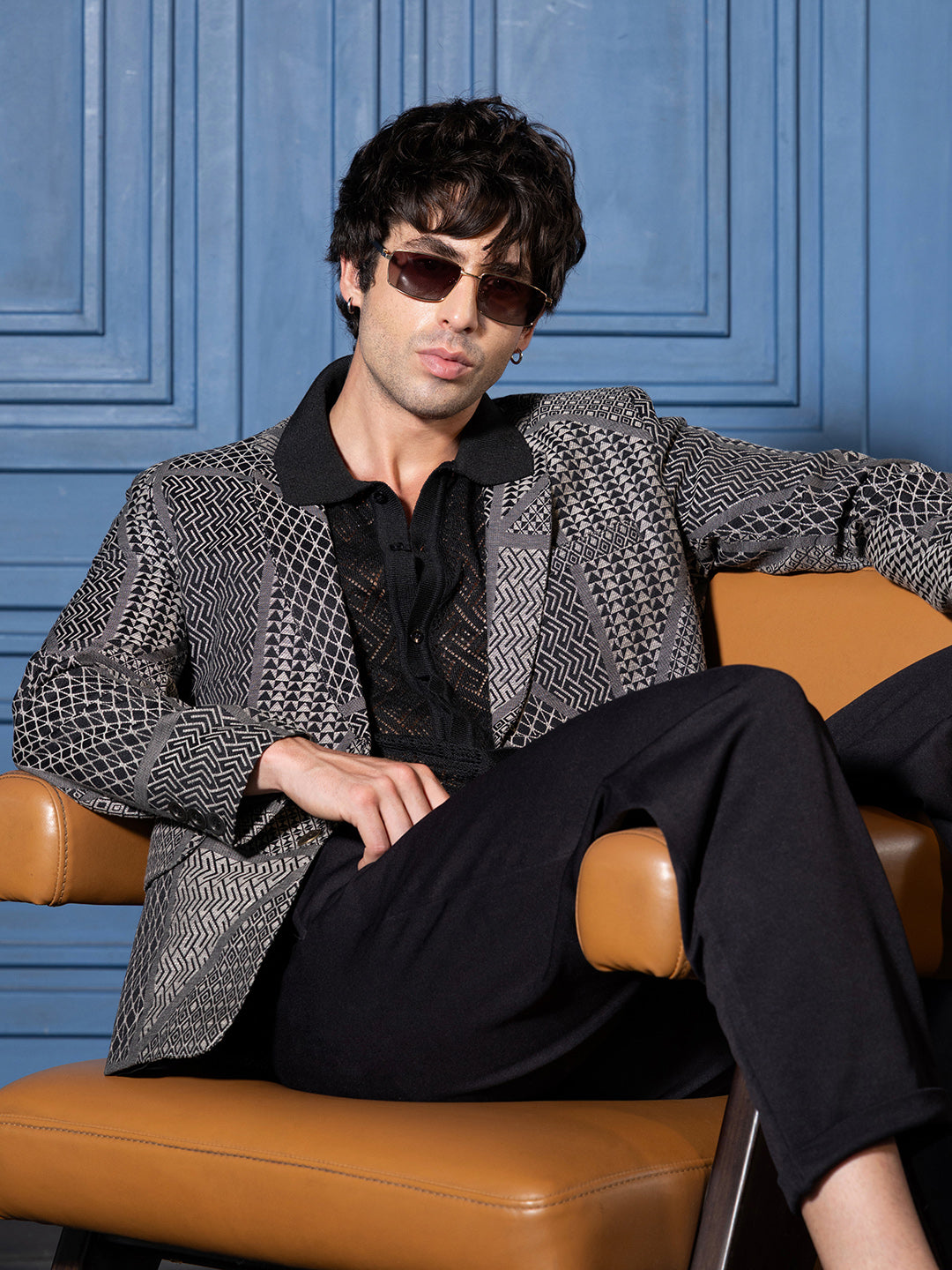 black tailored-fit blazer with a subtle geometric jacquard pattern.