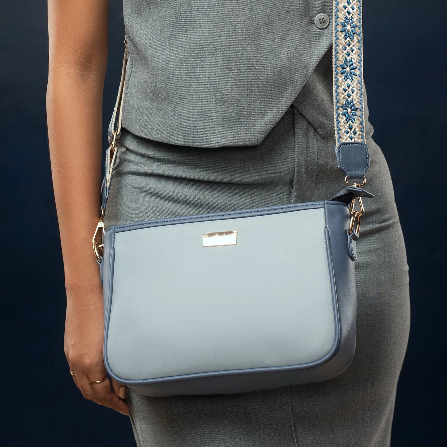 Stylish blue sling bag for women with decorative strap and sleek design for everyday use