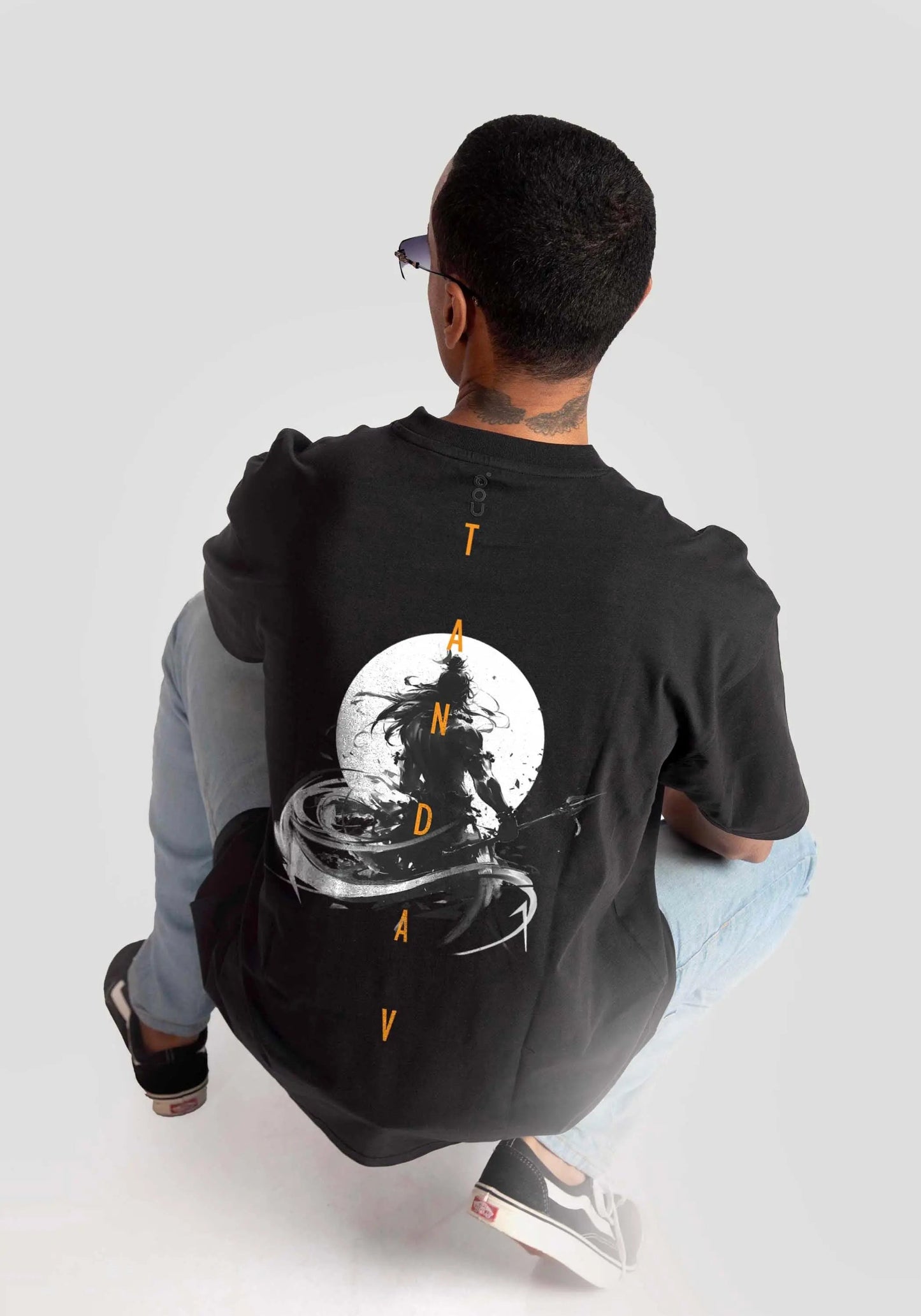Stylera Lifestyle charcoal black oversized t-shirt with graphic design worn by seated man