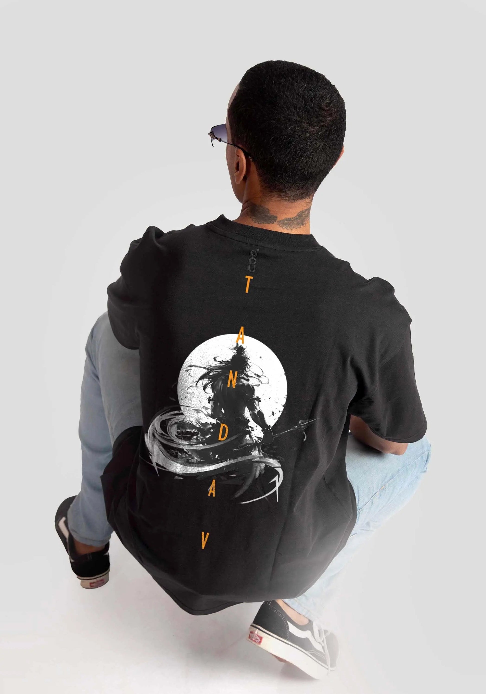 Stylera Lifestyle charcoal black oversized t-shirt with graphic design worn by seated man